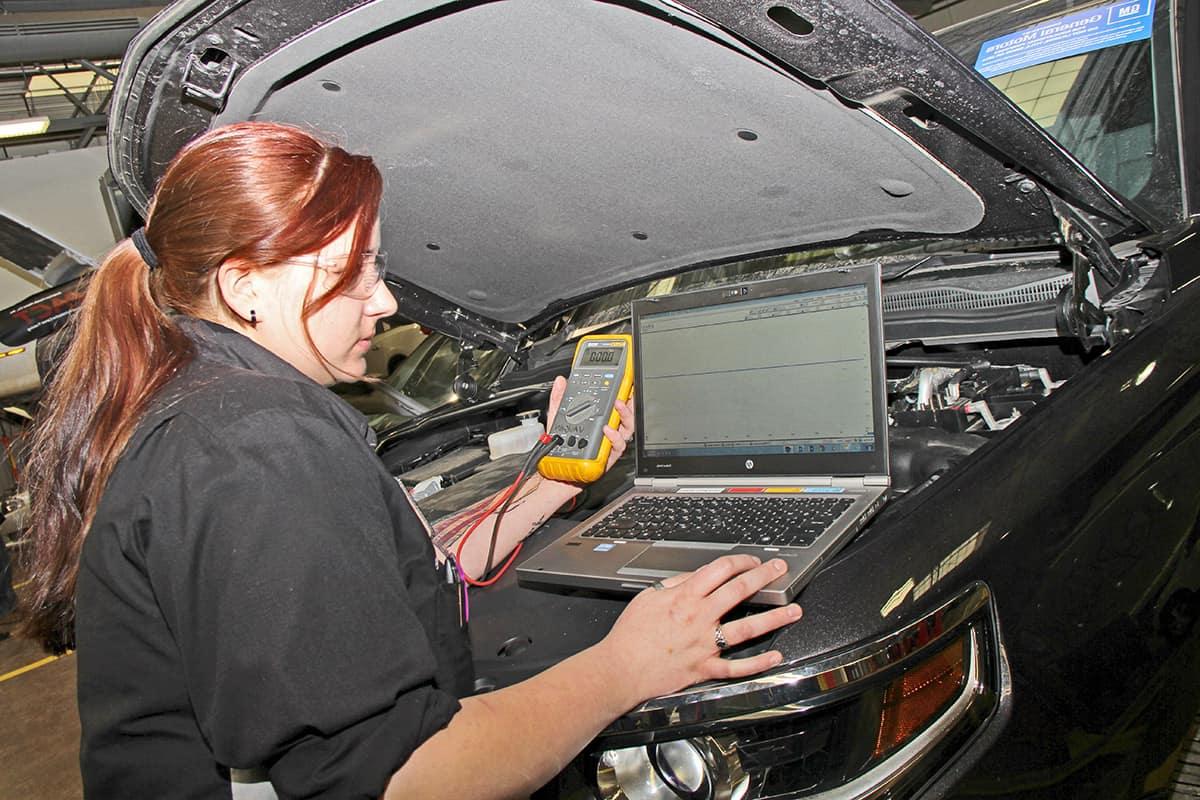 Student in the Automotive Technology Certificate Program working on a car.