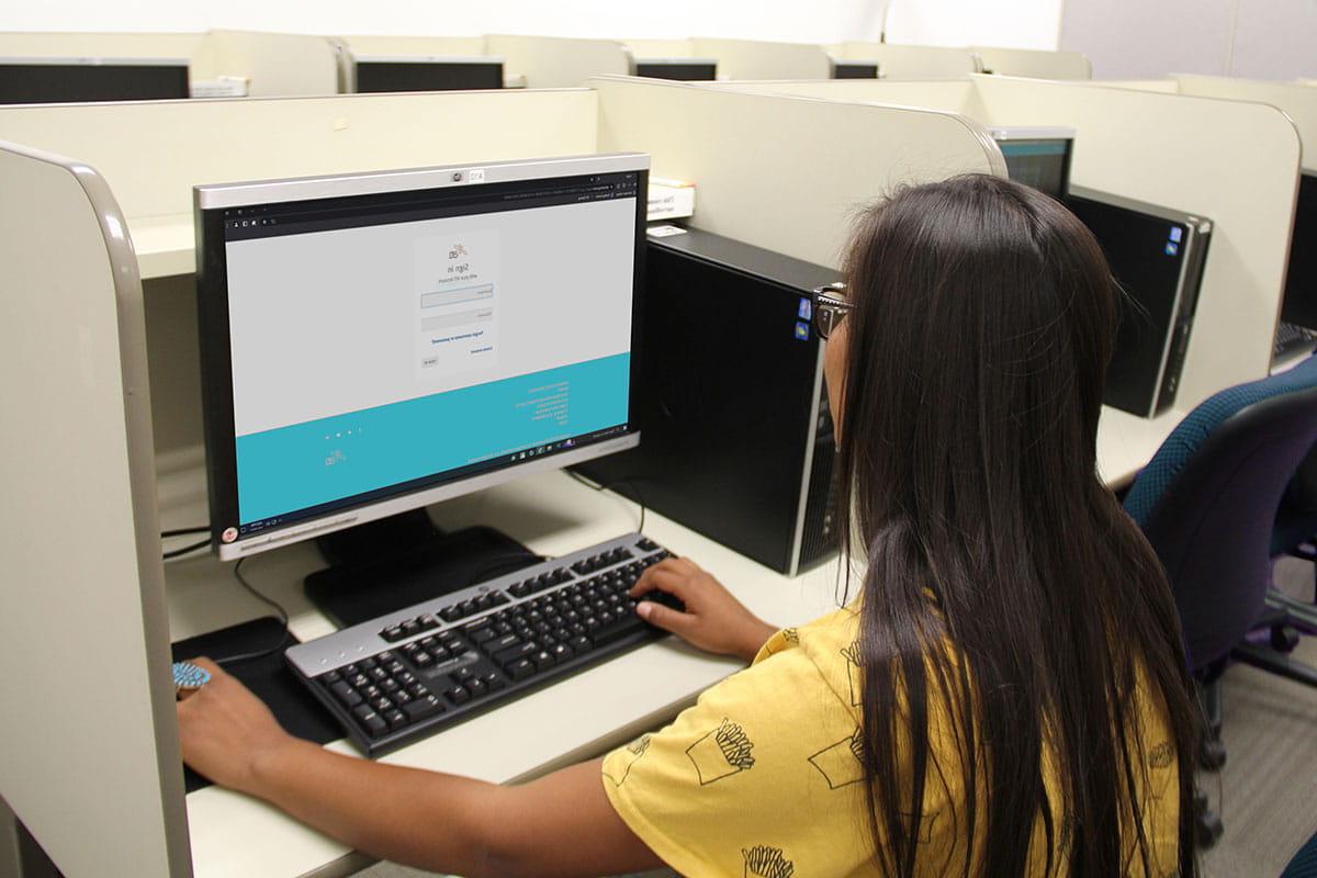 Young woman sits at computer in the testing center.